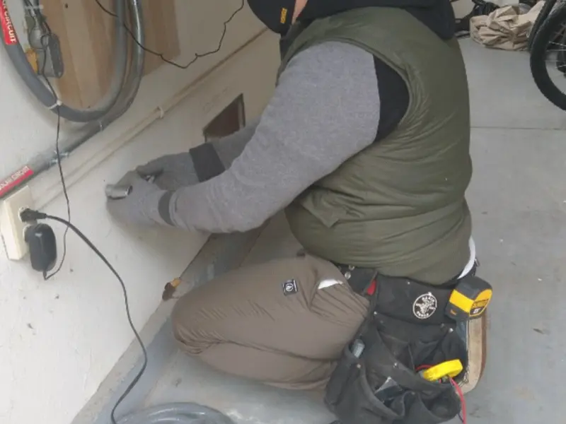 Electrician performing outlet wiring in a Santa Monica garage